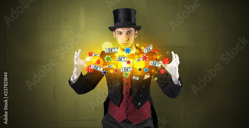 фотография Young illusionist in tails hold between hands gambling staffs with super power