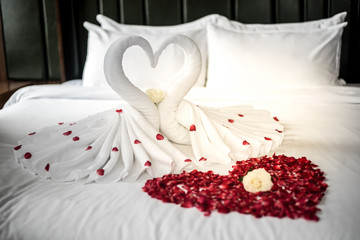 Bedroom bride and groom, luxury bedroom, white linen, white swan, red petal, red heart