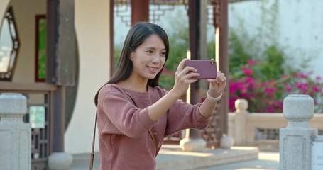 Poster - Woman take photo on cellphone in chinese garden