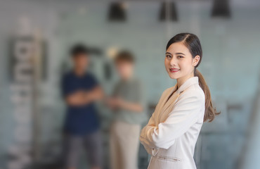 Young Asian happy woman stand in an office.