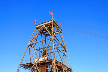 Wall Mural - Iron ore drilling derrick in the blue sky background