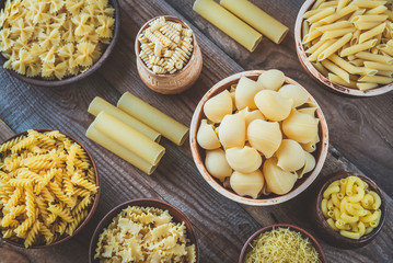 Canvas Print - Various types of pasta on rustic background