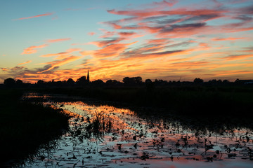 Sticker - Colorful sunset over the dutch countryside with reflection in the water of a pond