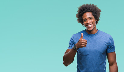 Wall Mural - afro american man over isolated background doing happy thumbs up gesture with hand. approving expres