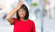 © Krakenimages.com - Beautiful young african american woman wearing glasses over isolated background surprised with hand on head for mistake, remember error. Forgot, bad memory concept.