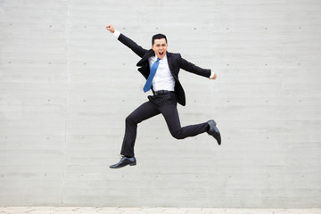 excited Young businessman running and jumping