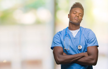 Poster - Young african american doctor man over isolated background wearing surgeon uniform skeptic and nervous, disapproving expression on face with crossed arms. Negative person.