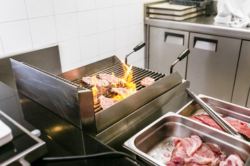 grilling steaks with fire at the kitchen