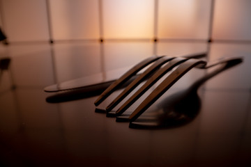 Wall Mural - Cutlery spoon, fork and knife on black background