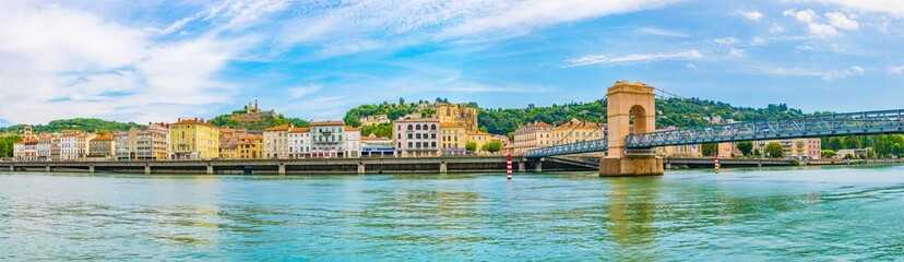 Wall Mural - Cathedral in Vienne viewed behind a pedestrian bridge over river Rhone, France