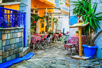 Wall Mural - traditional colorful Greece series - cute taverns in narrow streets. Skiathos island