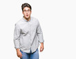 © Krakenimages.com - Young handsome man wearing glasses over isolated background afraid and shocked with surprise expression, fear and excited face.