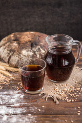 Wall Mural - Kvass with rye bread on dark wooden background. 