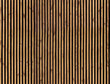 Seamless pattern of modern wall paneling with vertical wooden slats for background. Raw material of natural brown wood lath.