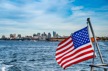 American Flag Over  Hudson River With Manhattan And New Jersey Buildings.