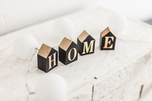Word Home On White Wooden Background With Copy Space. Home Word Concept. Home Word Written On Black Wooden Houses.