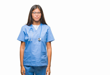 Wall Mural - Young asian doctor woman over isolated background with serious expression on face. Simple and natural looking at the camera.