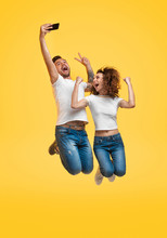 Couple Jumping And Taking Selfie