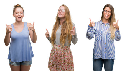 Wall Mural - Collage of group of blonde women over isolated background success sign doing positive gesture with hand, thumbs up smiling and happy. Looking at the camera with cheerful expression, winner gesture.