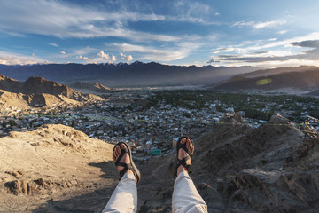 Wall Mural - a happy man enjoying beautiful aerial landscape view point in leh city, in ladakh region, india. tra