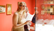© JackF - Woman holding brochure in museum of arts