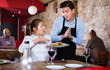 © JackF - Displeased young woman conflicting with apologetic waiter because of poor quality of dish