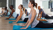 © JackF - Glad women and men exercising during yoga class