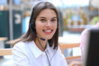 © ty - Female customer support operator with headset and smiling.
