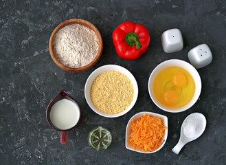 Wall Mural - Ingredients for cooking corn unleavened bread: wheat flour, red peppers, corn flour, oil, salt, pepper, grated cheddar cheese, baking powder, eggs, milk or buttermilk.