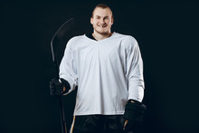 Portrait Of Cheerful Proud Caucasian Hockey Player Smiling With Teeth, Looking In Camera With Happy And Relaxed Face Expression, Posing After Victory In Hockey Match With Stick, Isolated On White