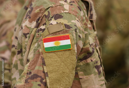 Valokuvatapetti Flag of Kurdistan on soldiers arm