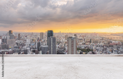 Fotografía Osaka city skyline, downtown business district in sunset with empty concrete flo