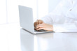 © rogerphoto - Close-up of business woman hands typing on laptop computer. Secretary at work in office