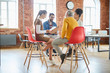 © pressmaster - Group of four colleagues sitting on chairs and discussing data or their new ideas for new business project