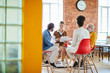 © pressmaster - Several colleagues sitting in circle during business discussion or consultation about features of modern company