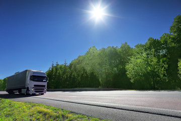 Wall Mural - Truck transport on the road at sunset and cargo 