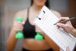 © Maksymiv Iurii - Fitness plan. Sports trainer amounts to workout plan close-up