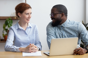 diverse businesspeople client and consultant sitting at desk during business meeting. mentor and emp