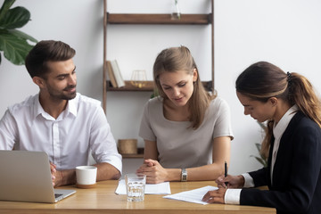 Sticker - After successful job interview mixed race female candidate was hired for position signing employment agreement. Businesspeople sitting at desk finishing negotiations affirm contract with signature