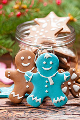 Poster - Colorful Christmas cookies in a jar and wooden table