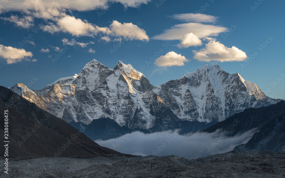Mountain Kangtega above and below the clouds. Himalayas, Nepal - obrazy, fototapety, plakaty 