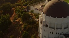 Cinematic Aerial Of Griffith Observatory With  The Hollywood  Sign As Background / Los Angeles, California 