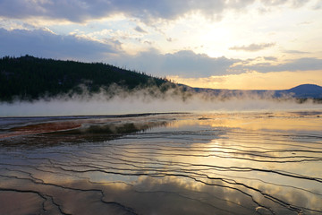 Wall Mural - Fiery orange sunset over the Grand Prismatic pool in Yellowstone National Park, United States