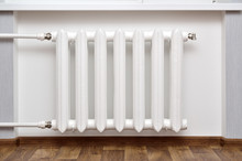 Pipes And A White Heating Radiator Heat The Room.