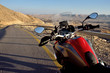 Red motorbike on the road in Negev desert near Big crater,Israel,Middle East