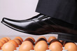 Man walking on eggs.  An expression which means you are in a difficult position and must be very careful