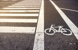 Fototapeta Do pokoju - Bike lane symbol with crosswalk on asphalt street