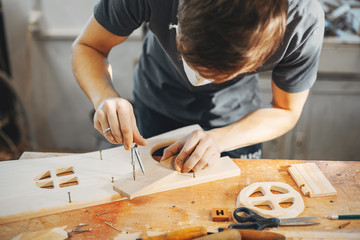 Wall Mural - The carpenter works with a tree