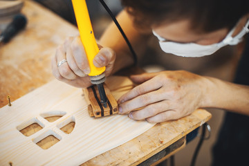 Wall Mural - The carpenter works with a tree