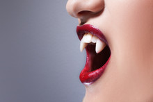 Sexy Vampire. Women's Lips With Red Lipstick. Screaming Mouth With Vampire Fangs
